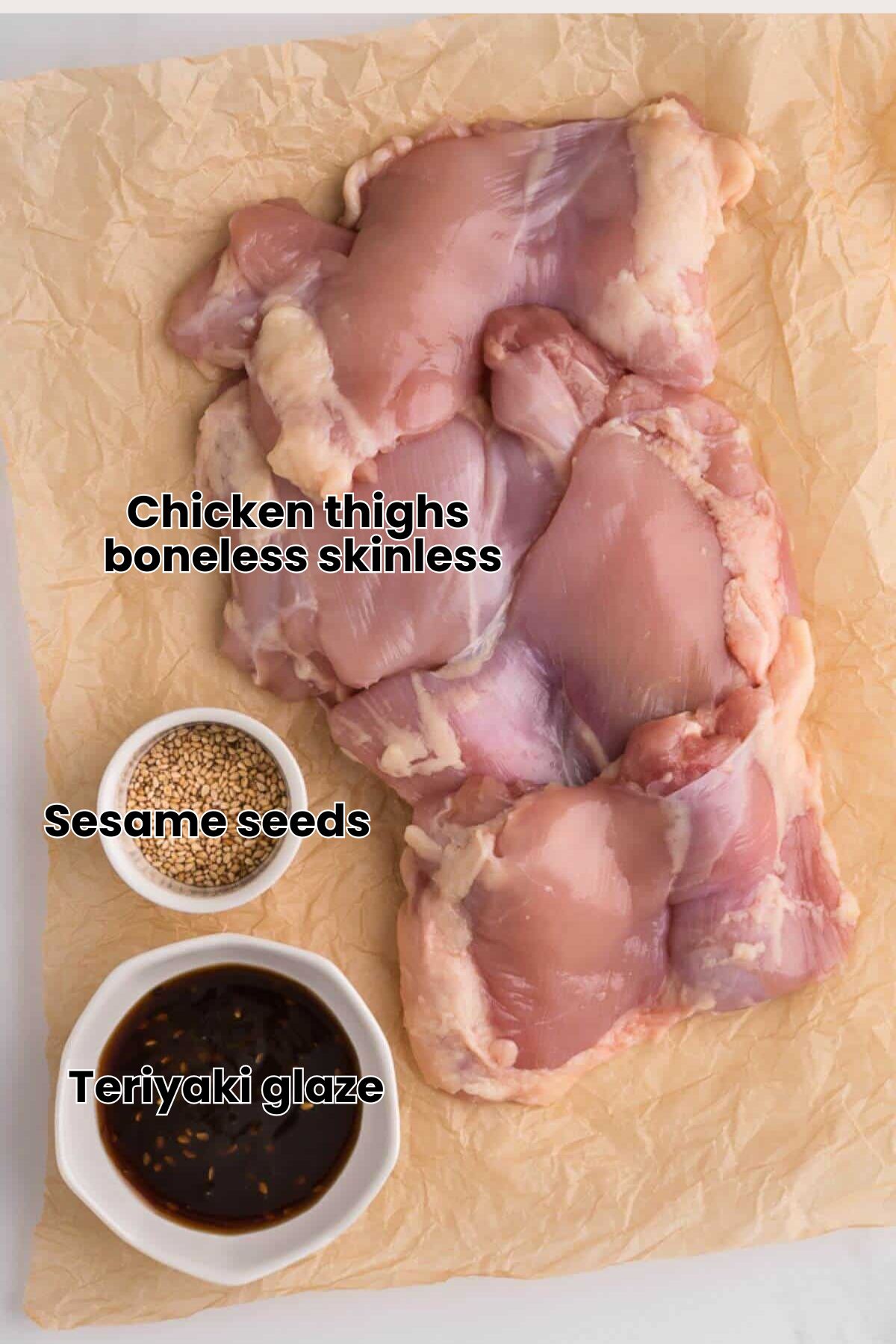 Raw chicken thighs on parchment paper with small bowls of sesame seeds and a dark sauce.