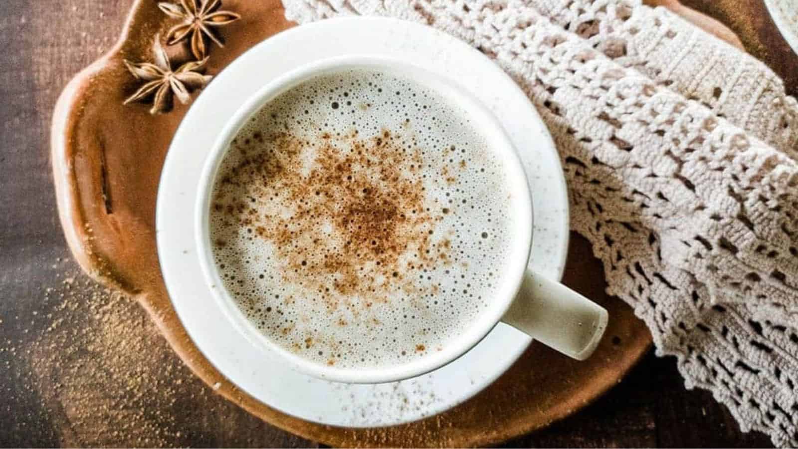 Chocolate Chai Latte in white teacup on clay dish with lace napkin.