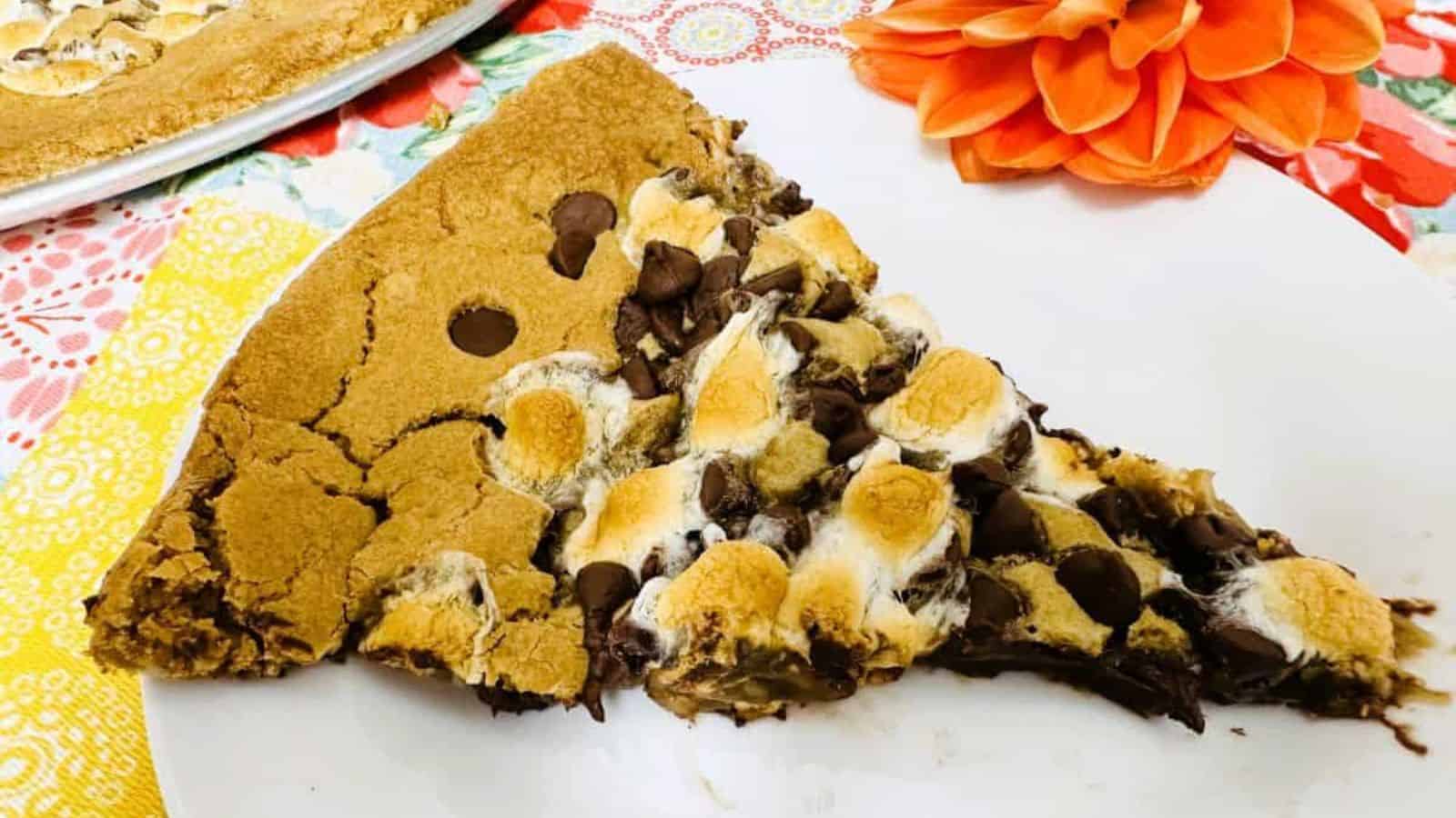 A slice of chocolate chip pizza on a plate.