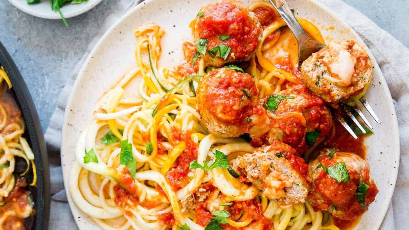 Cheddar stuffed turkey meatballs served with zoodles.