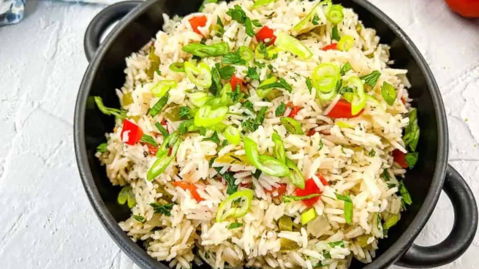 Mediterranean Rice in a black bowl on concrete.