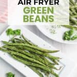 Cooked green beans served on white plates, garnished with parsley, with text overlay reading "Easy Air Fryer Green Beans" and website "littlebitrecipes.com.