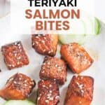 Plate of air fryer teriyaki salmon bites garnished with sesame seeds and served with cucumber slices; dipping sauce in the background.