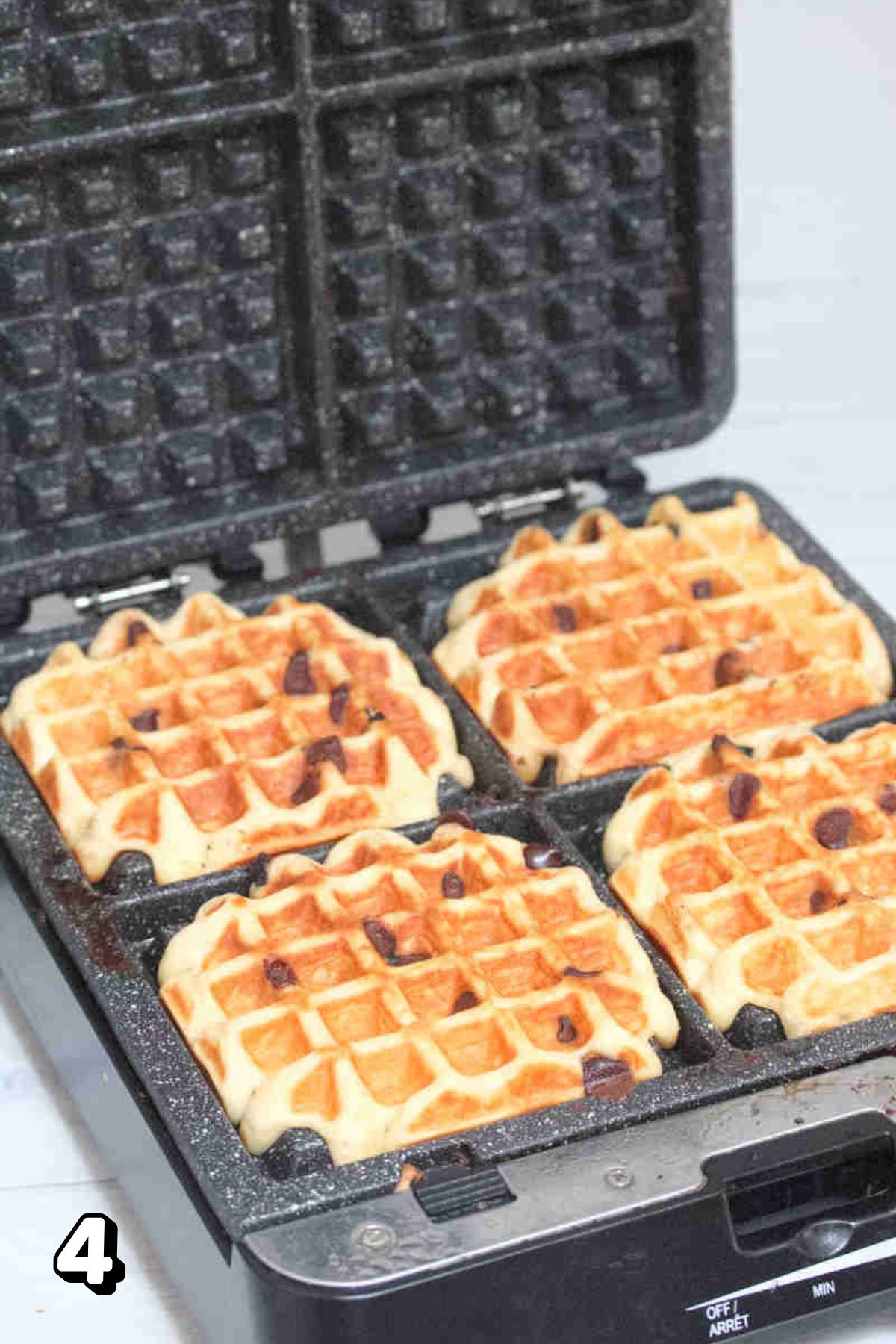 Chocolate chip waffles in a cast iron waffle iron.