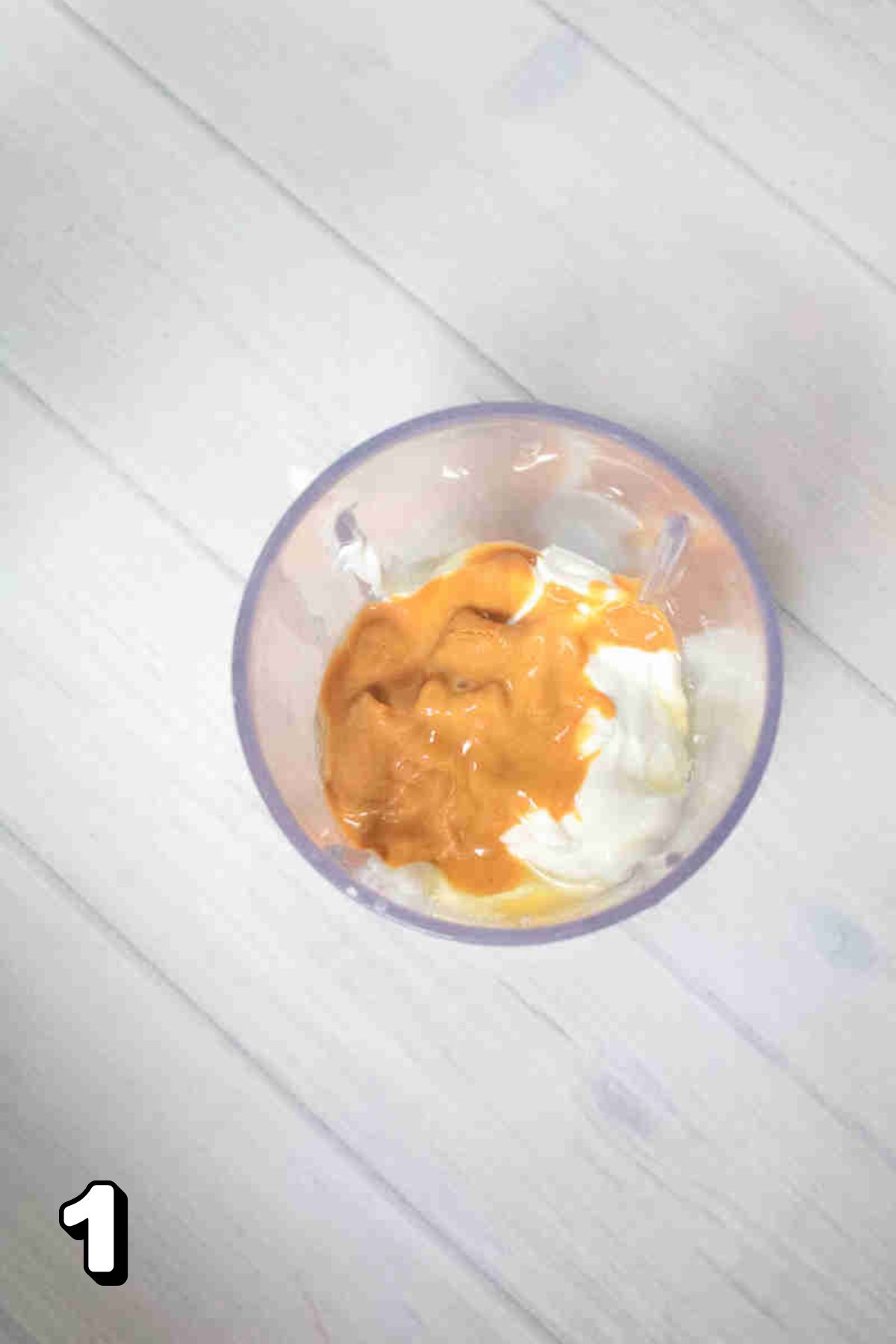 A blender with yogurt and peanut butter.