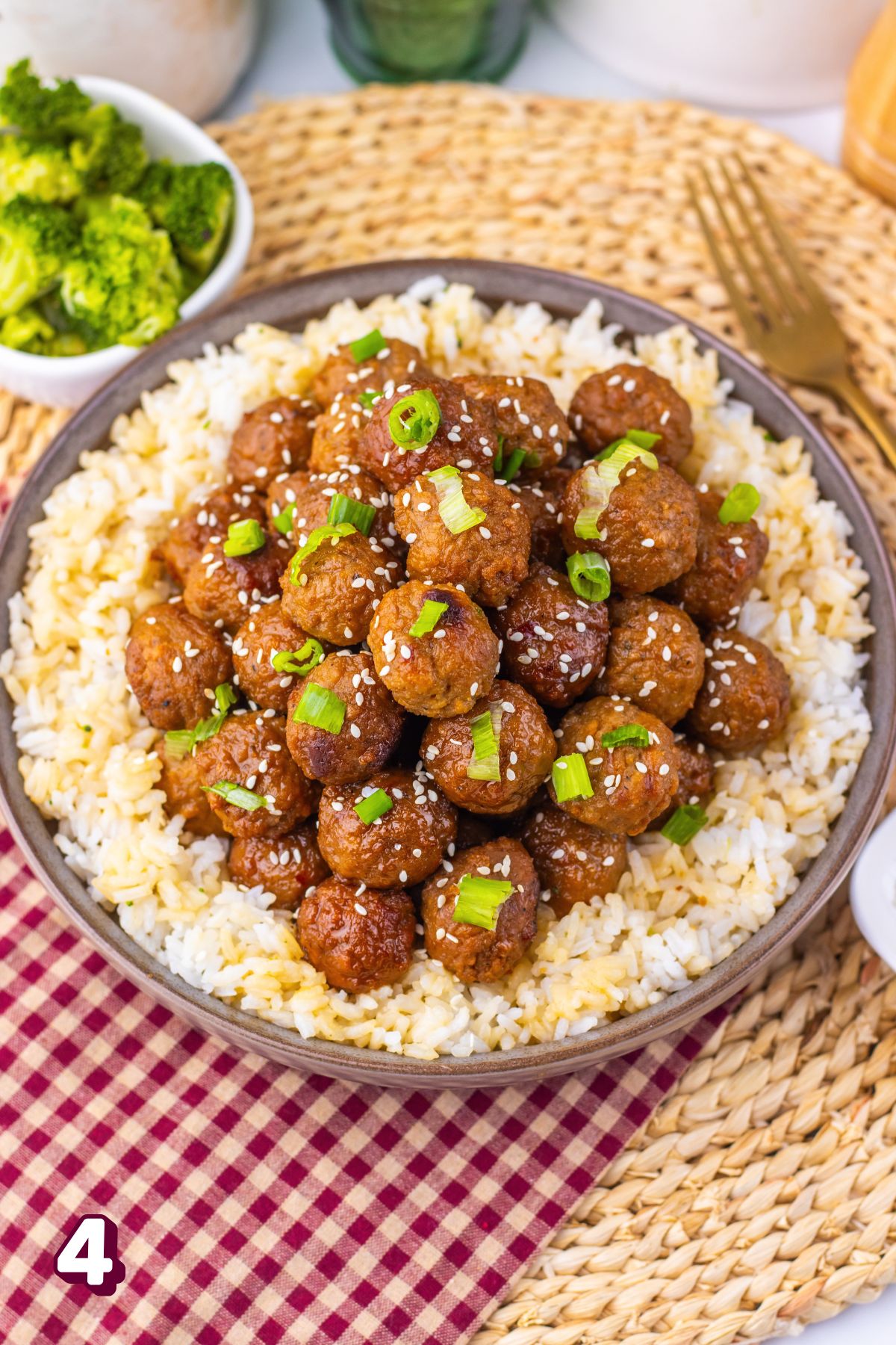 Mongolian meatballs with green onions on them over rice.