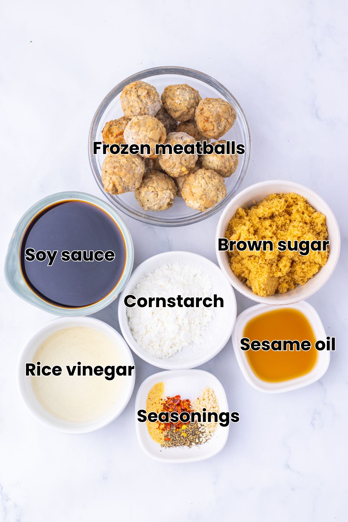 Frozen meatballs, sauce, and seasonings to make Mongolian meatballs in white bowls with text over top.