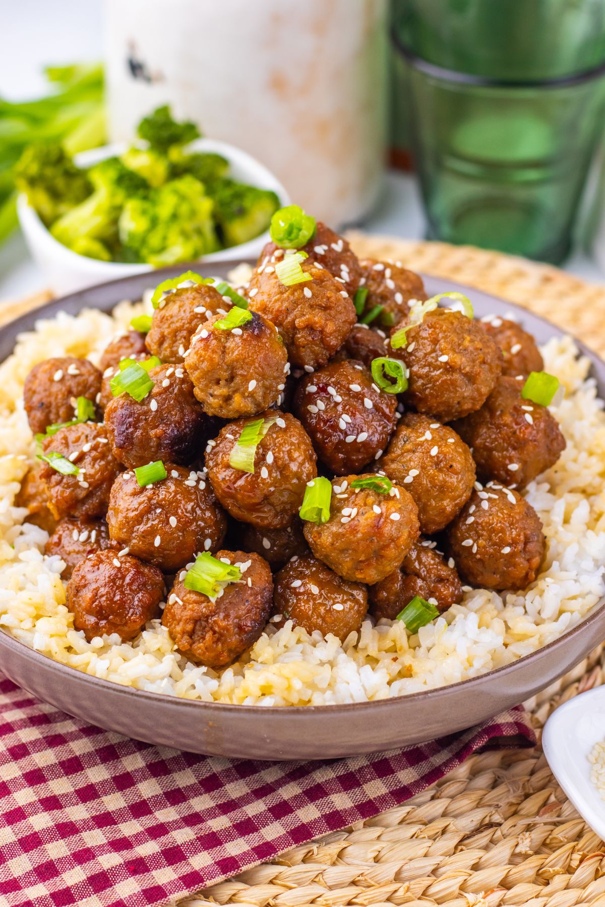 Mongolian meatballs with green onions on them over rice.