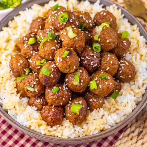 Mongolian meatballs with green onions on them over rice.