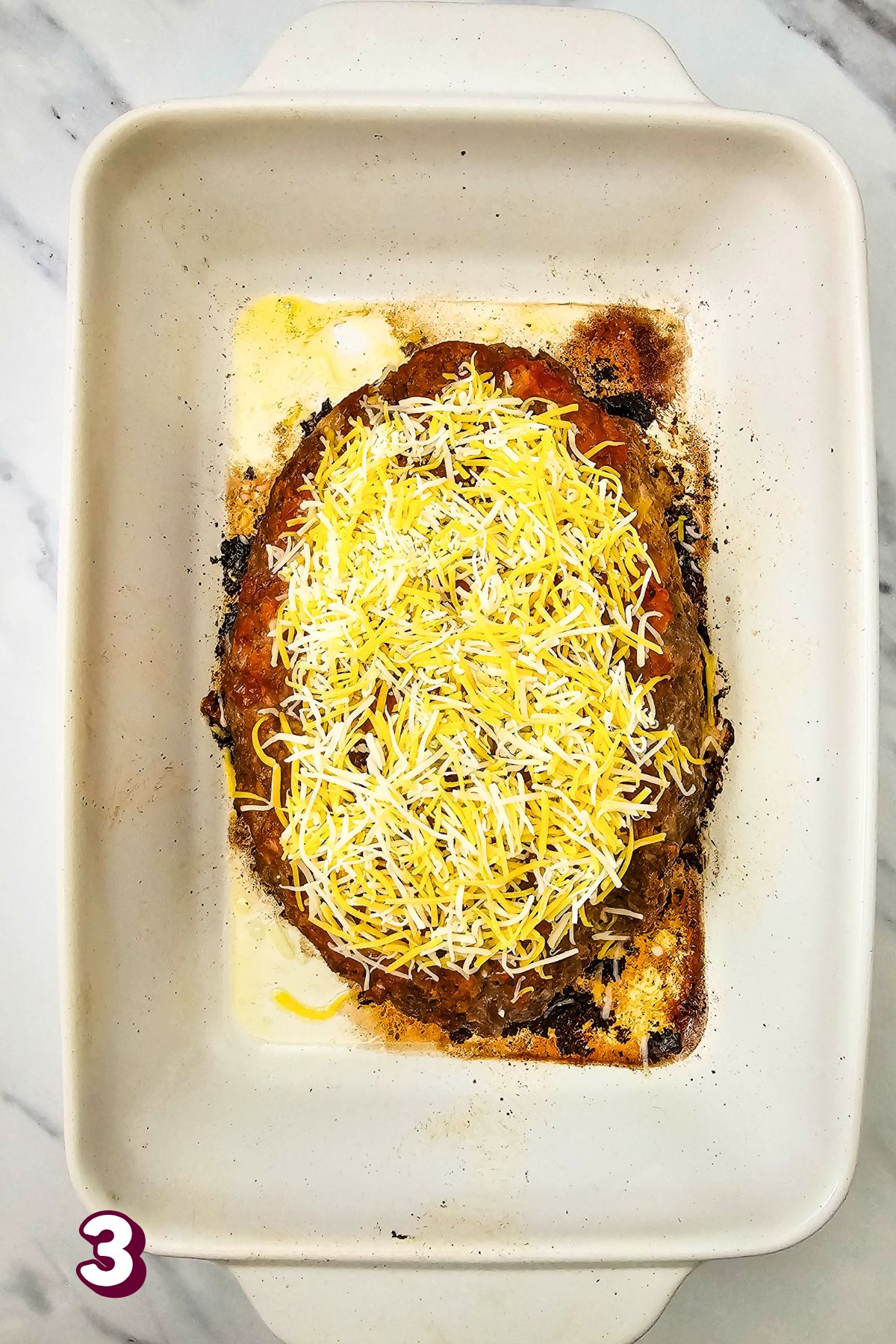 Baked, cheesy salsa meatloaf in a white baking dish.