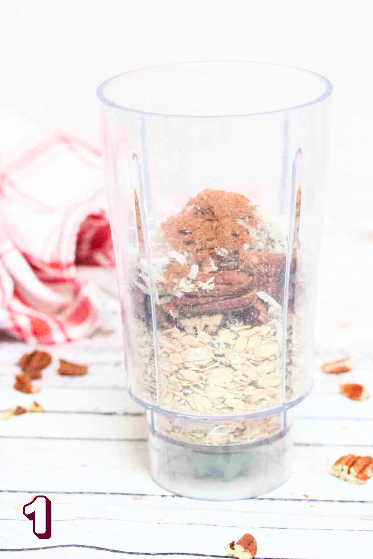 Mini blender with oats, pecans, and cinnamon in it.