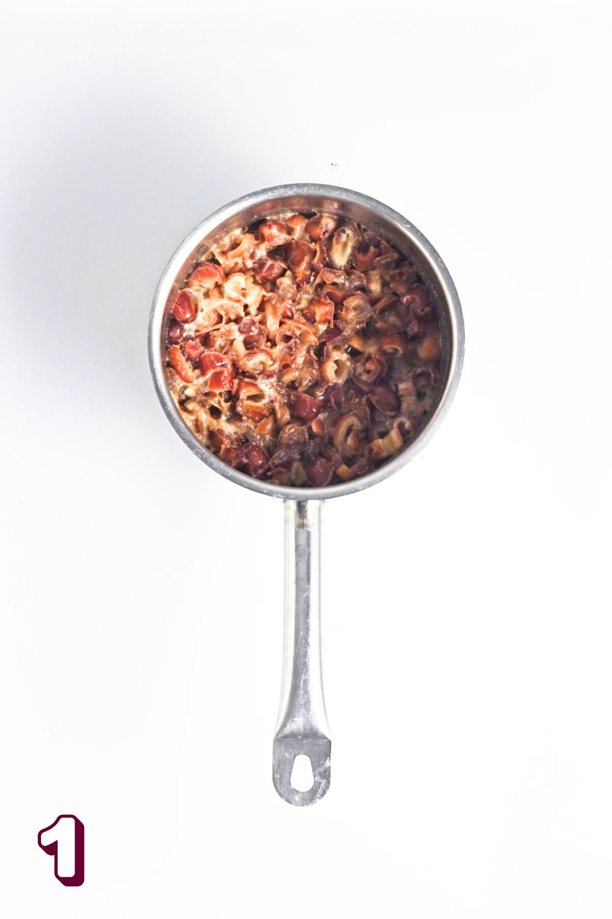 Dates being cooked down in a small saucepan.
