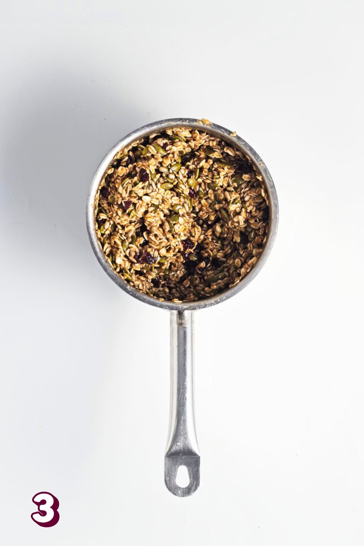 Small pot with homemade granola mixture in it.