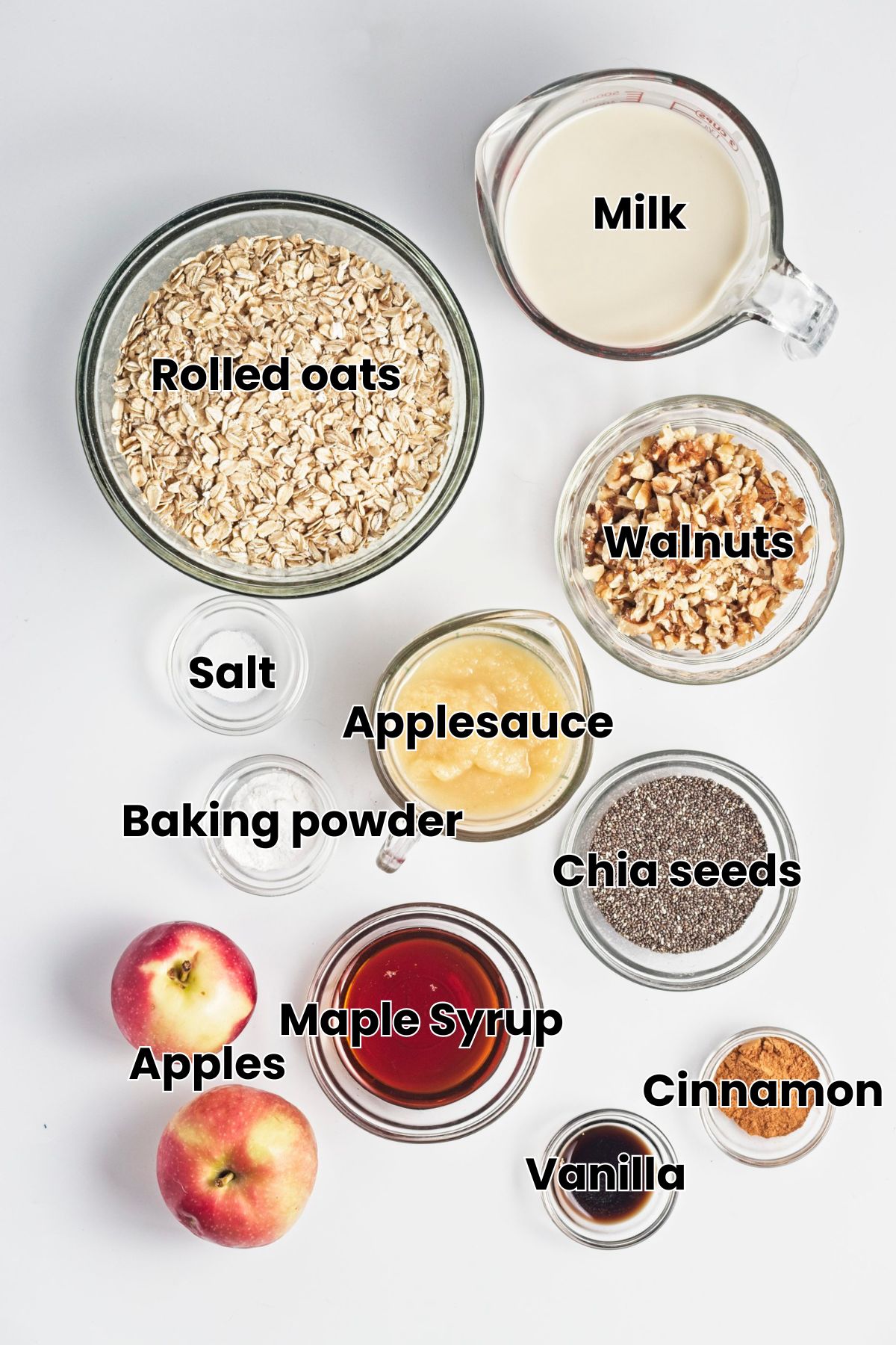 Multiple ingredients like oats, walnuts, maple syrup, and applesauce in glass bowls with text labels over the top.