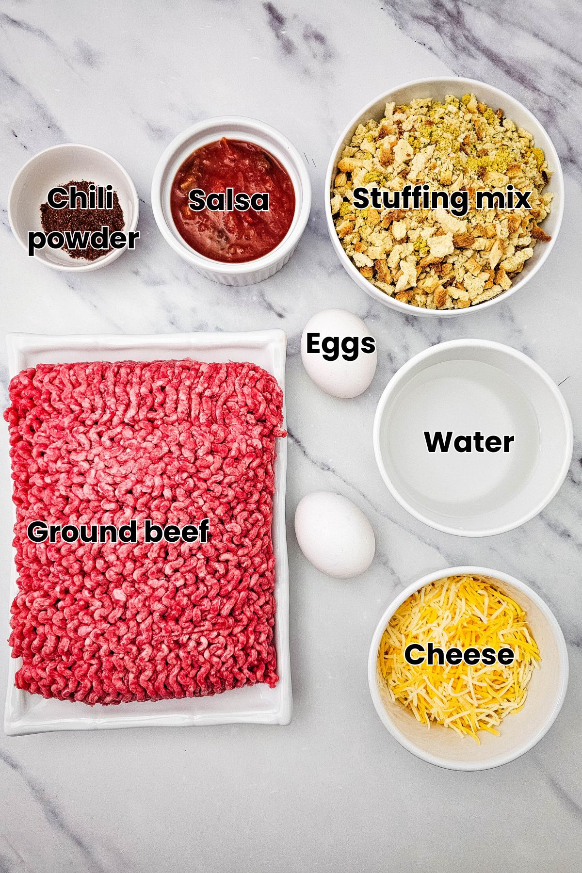 Ground beef, cheese, eggs, and stuffing mix in white bowls with text over the bowls.