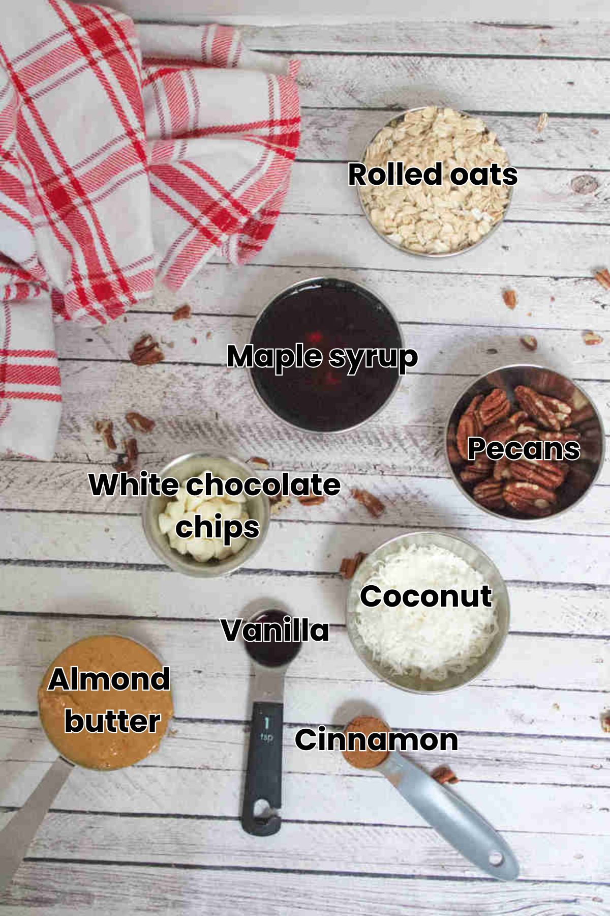 Multiple ingredients like pecans, oats, and maple syrup in measuring cups with text labels over the top.