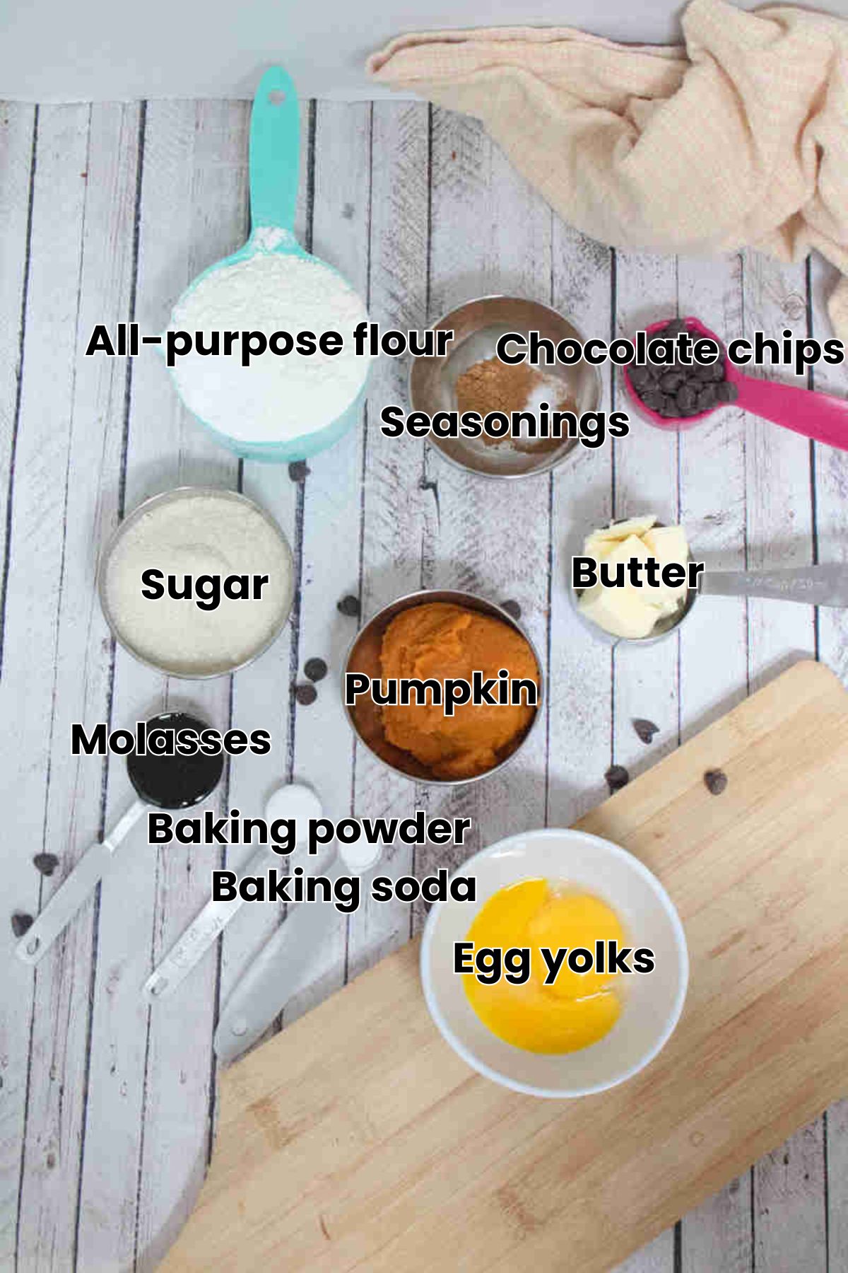 Multiple ingredients in ramekins like pumpkin, egg yolks, butter, seasonings and more with text ingredients over the bowls.