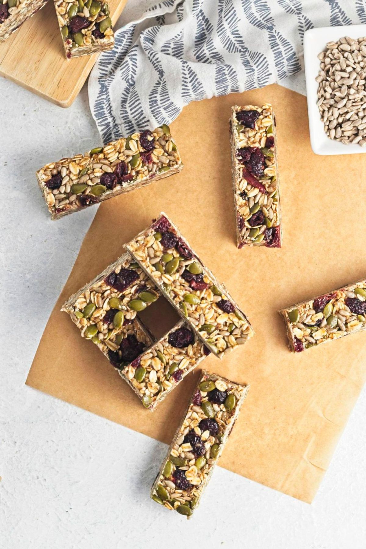 No bake granola bars stacked on parchment paper.