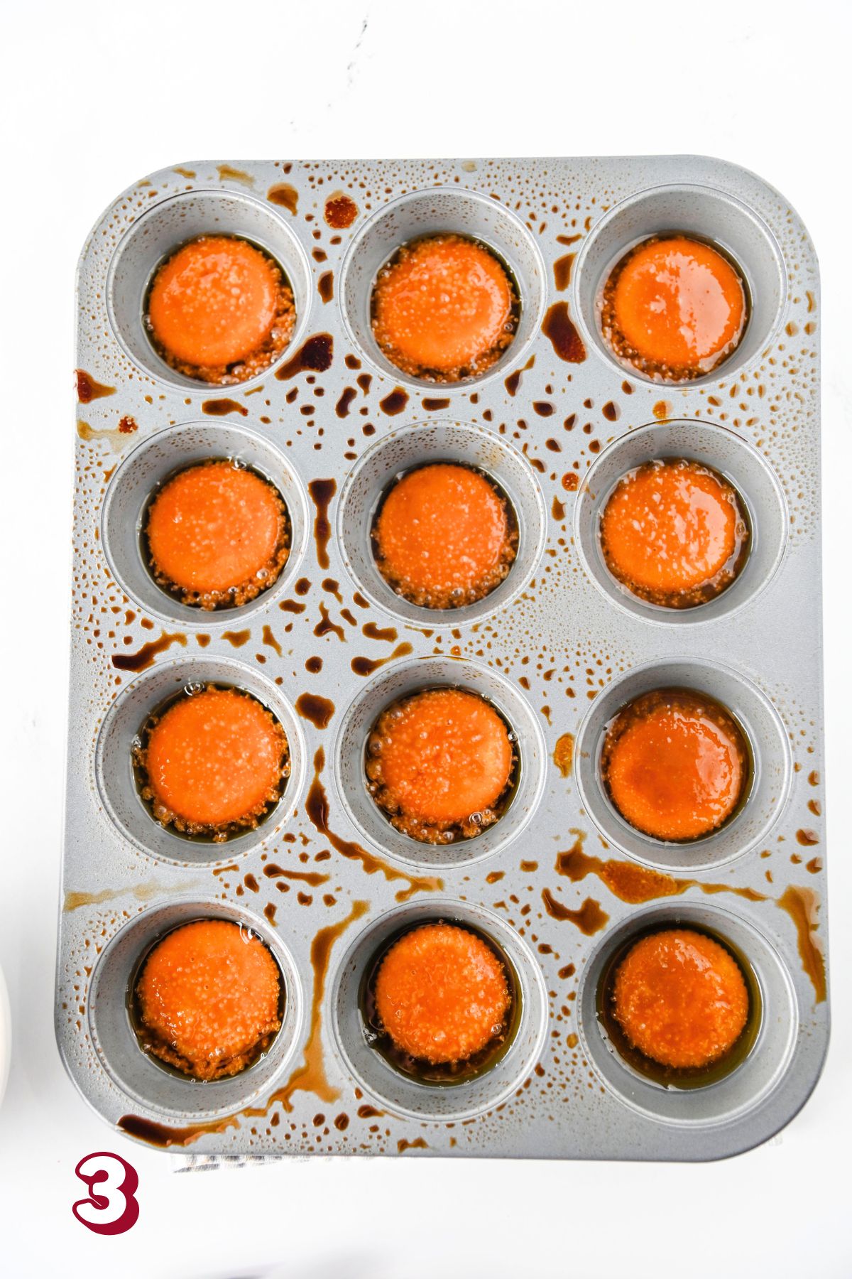 Muffin tin with Ritz crackers topped with a boiled brown sugar.