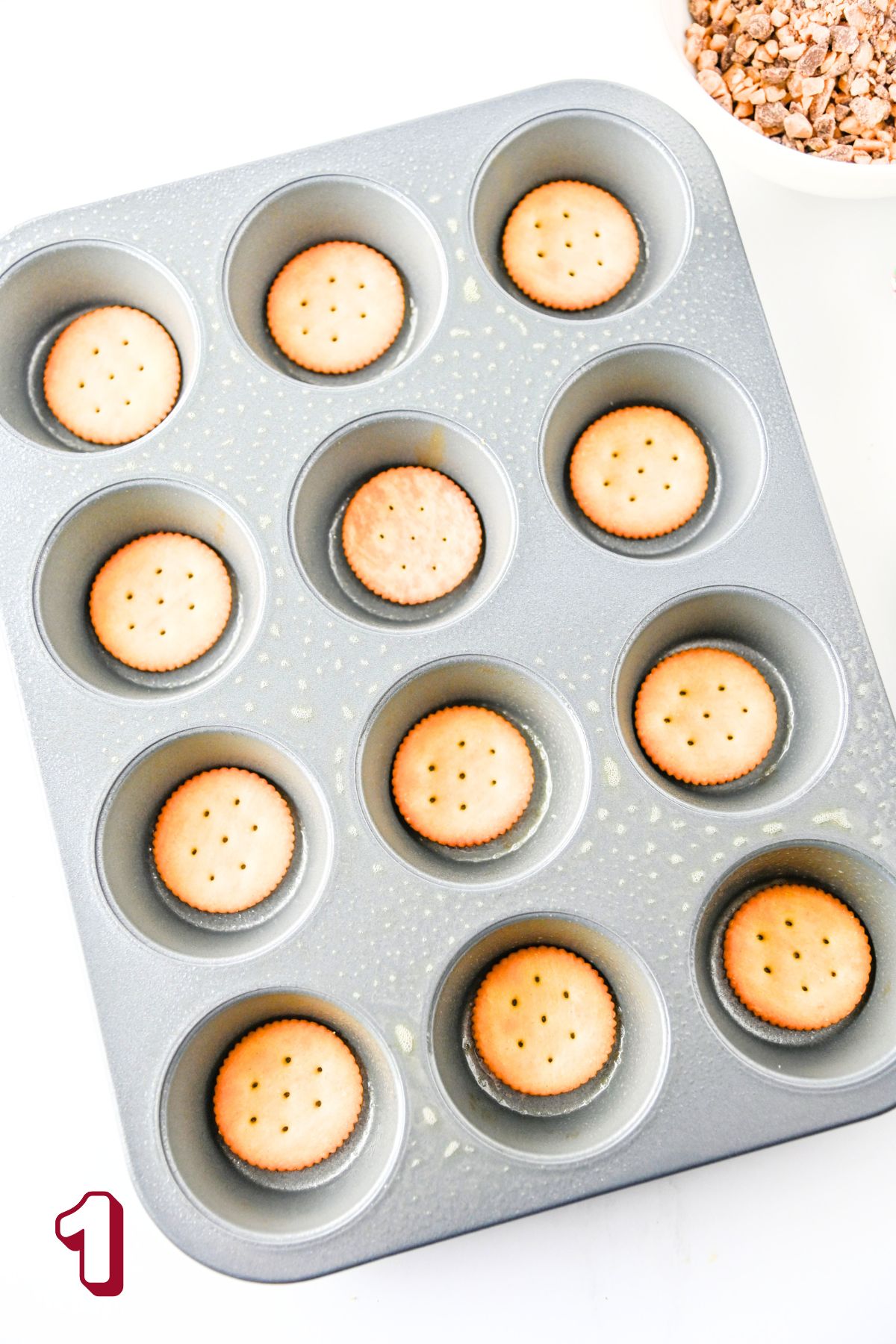 Muffin tin with Ritz crackers in each.